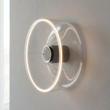 Lâmpada LED donut E27 em vidro transparente, Ø 195 mm, como aplique de parede com um halo de luz quente
