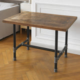 Base de mesa de jantar, ferro fundido e aço envernizado, em H Ø 42 mm, em ambiente sob um tampo feito de uma antiga porta de madeira